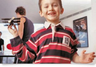 Child playing with toy plane